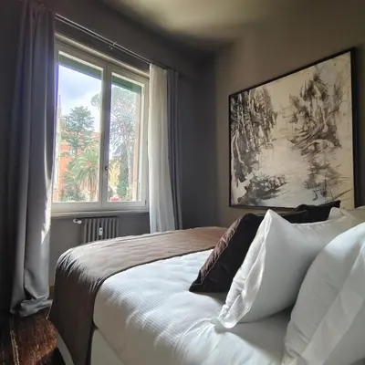 a bedroom with a large bed and a window at Ada Home in Rome