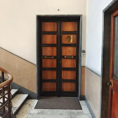 a wooden door in a room with stairs at Ada Home in Rome