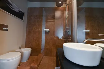 a bathroom with a sink and a toilet and a shower at Ada Home in Rome