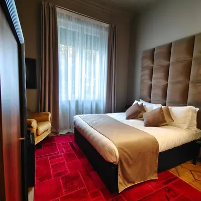 a bedroom with a large bed with a large window at Ada Home in Rome