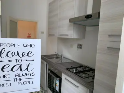 a kitchen with a sign that says people who love to eat at Chiaretta Guest House in Rome