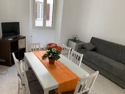 a living room with a table and a couch at Chiaretta Guest House in Rome