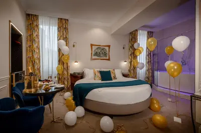 a room with a bed with balloons in it at Torre Argentina Relais - Residenze di Charme in Rome