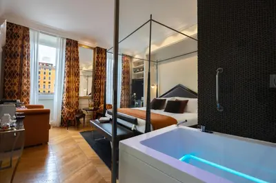 a hotel room with a tub and a bedroom at Torre Argentina Relais - Residenze di Charme in Rome