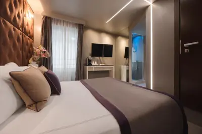 a bedroom with a large bed and a television at Torre Argentina Relais - Residenze di Charme in Rome