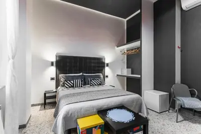 a bedroom with a large bed with a black headboard at Benincasa Bed&Breakfast in Rome