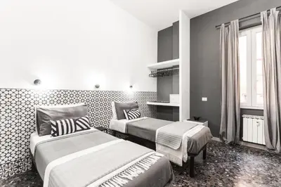 a hotel room with two beds and a window at Benincasa Bed&Breakfast in Rome