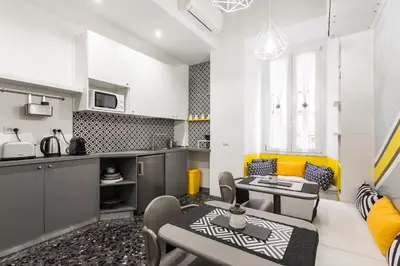 a kitchen and a living room with a table and chairs at Benincasa Bed&Breakfast in Rome