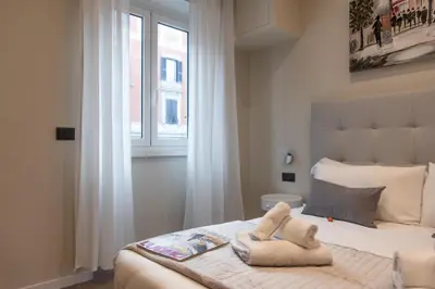 a bedroom with a bed with towels on it at XXIV Domus Luxury Suites in Rome
