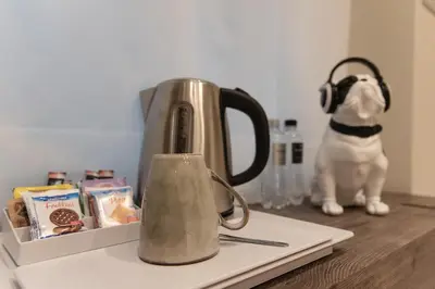 a tea kettle sitting on a counter with a dog at XXIV Domus Luxury Suites in Rome