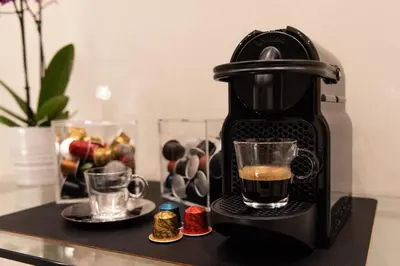 a coffee maker on a table with a cup of coffee at XXIV Domus Luxury Suites in Rome