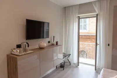 a living room with a television on a white wall at XXIV Domus Luxury Suites in Rome
