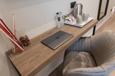 a desk with a laptop on top of it at XXIV Domus Luxury Suites in Rome
