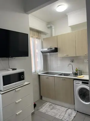a small kitchen with a sink and a microwave at Roman Art Apartment - Metro C to Colosseum in Rome