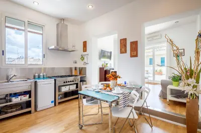 a kitchen and dining room with a table and chairs at Living by Vatican with panoramic terraces in Rome in Rome