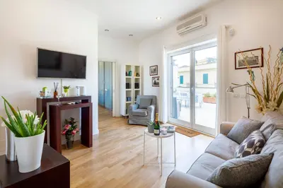 a living room with a couch and a tv at Living by Vatican with panoramic terraces in Rome in Rome