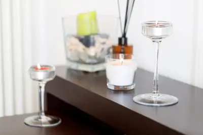 three wine glasses and candles on a table at Living by Vatican with panoramic terraces in Rome in Rome