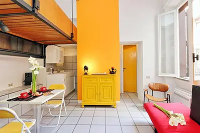 a kitchen with a yellow cabinet in a room at Welcome to Trastevere in Rome