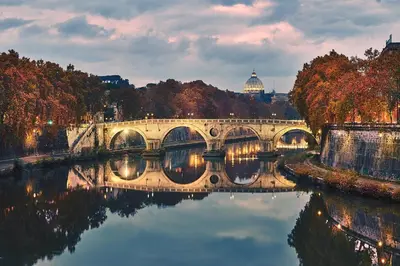 a bridge over a river with a view of a city at Welcome to Trastevere in Rome