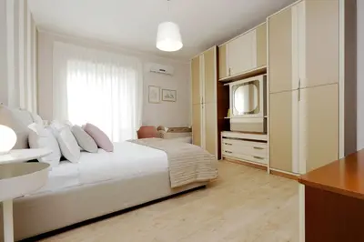 a bedroom with a white bed and a television at Elegant 3-Bed Apartment 10' Termini Wi-Fi AC in Rome