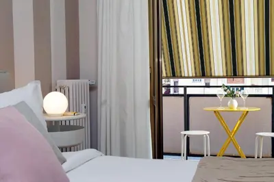a bedroom with a bed and a table with chairs at Elegant 3-Bed Apartment 10' Termini Wi-Fi AC in Rome