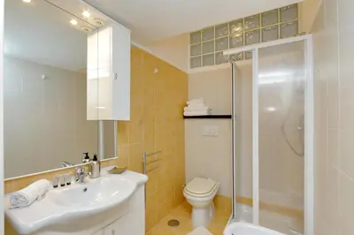 a bathroom with a sink and a toilet and a shower at Elegant 3-Bed Apartment 10' Termini Wi-Fi AC in Rome