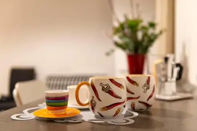 three coffee mugs sitting on a table at DOMUS FORTUNAE VATICANO in Rome