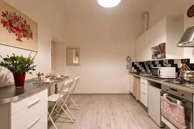 a kitchen with white cabinets and a counter top at DOMUS FORTUNAE VATICANO in Rome