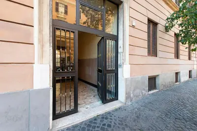 an entrance to a building with black doors at DOMUS FORTUNAE VATICANO in Rome
