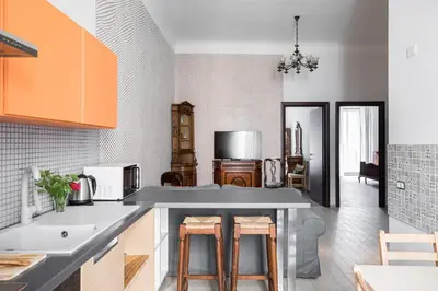 a kitchen with a counter with stools in it at Nobile Casa St.Maria in Rome