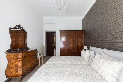 a bedroom with a large bed with a wooden headboard at Nobile Casa St.Maria in Rome