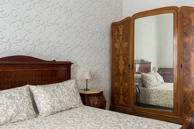 a bedroom with a bed and a large mirror at Nobile Casa St.Maria in Rome