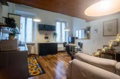 a living room with a couch and a dining room at Loft in Testaccio in Rome
