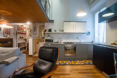 a kitchen with a couch and a chair in a room at Loft in Testaccio in Rome