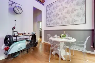 a room with a table and an old scooter in it at Klioos Apartment in Rome
