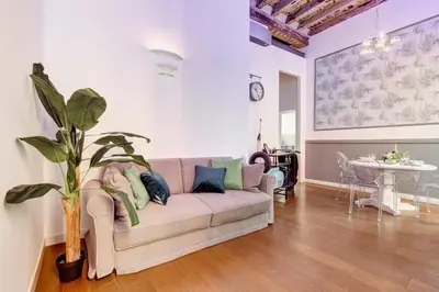 a living room with a couch and a table at Klioos Apartment in Rome