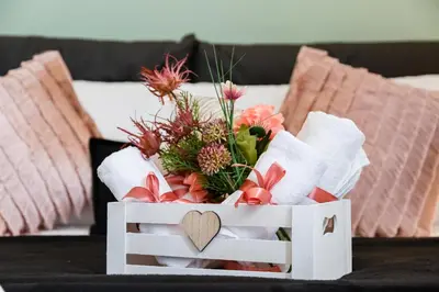 a white crate with a bouquet of flowers and a heart at Klioos Apartment in Rome