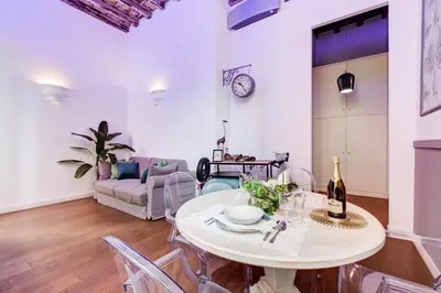a living room with a table and a couch at Klioos Apartment in Rome