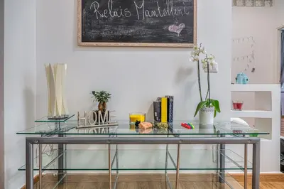 a glass table in a room with a chalkboard at Relais Mantellini in Rome