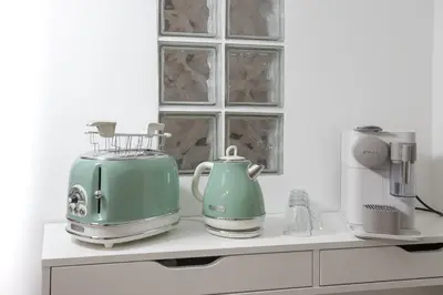 a kitchen counter with two appliances on a shelf at Relais Mantellini in Rome