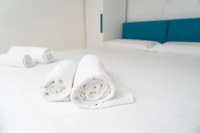 a bathroom with white towels on a white wall at SvHome in Rome