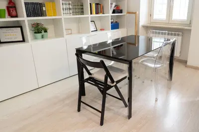 a glass table and a chair in a room at SvHome in Rome