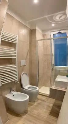 a bathroom with a toilet and a sink and a shower at A un passo dal centro in Rome