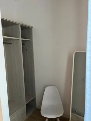 a white closet with a white chair and a mirror at A un passo dal centro in Rome