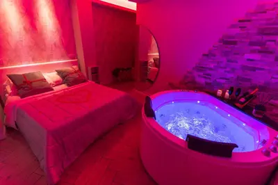 a bedroom with a tub and a bed and a bed and a bed sqor at Silver Suite Coliseum in Rome