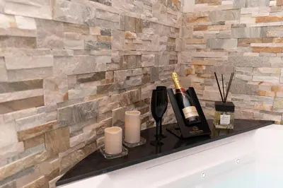a counter with two bottles of wine and candles at Silver Suite Coliseum in Rome