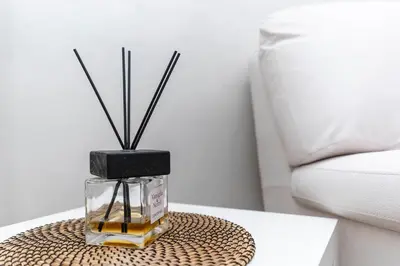a glass jar with sticks in it on a table at Silver Suite Coliseum in Rome