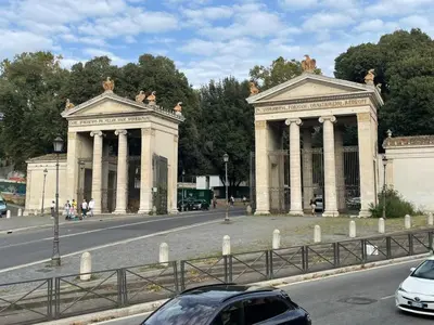 a large white building with pillars on the side of a road at Center House Colosseo in Rome