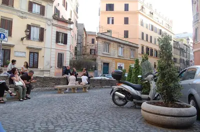 a scooter parked on a street in a city at Center House Colosseo in Rome
