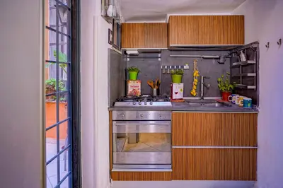 a small kitchen with a stove and a sink at Center House Colosseo in Rome